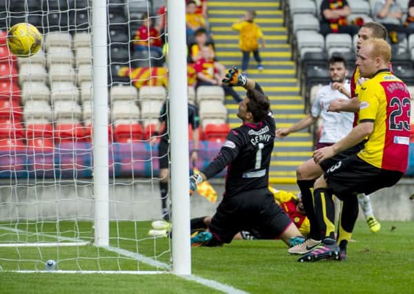 Tony Watt drives the ball home for Hearts' winner at Partick. Pic: SNS