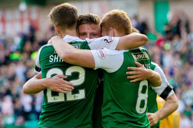 Jason Cummings is mobbed by Andrew Shinnie and Fraser Fyvie following the striker's now customary goal. Pic: SNS