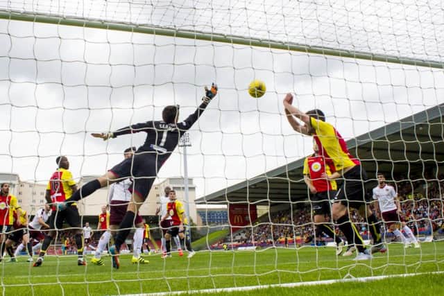 Callum Paterson's header flies past Tomas Cerny to give Hearts the lead in Maryhill. Pic: SNS