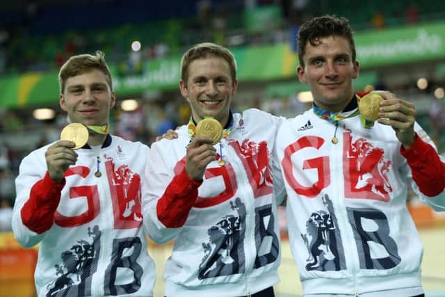 RIO DE JANEIRO, BRAZIL - AUGUST 11:  (L-R) Gold medalists Philip Hindes, Jason Kenny and Callum Skinner of Great Britain celebrate on the podium after winning the Men's Team Sprint Track Cycling Finals on Day 6 of the 2016 Rio Olympics at Rio Olympic Velodrome on August 11, 2016 in Rio de Janeiro, Brazil.  (Photo by Bryn Lennon/Getty Images)