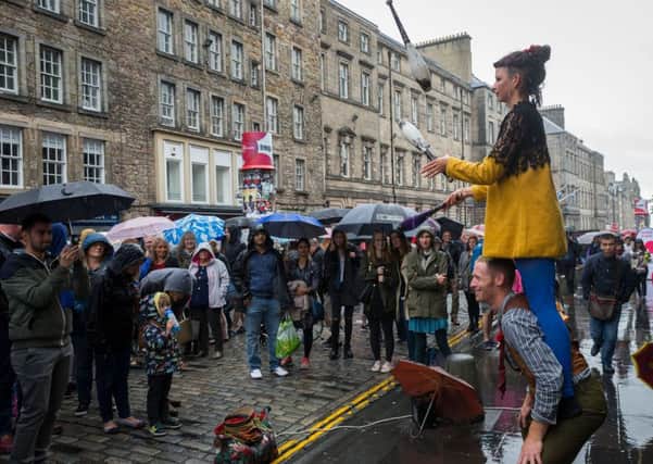 Festival. Pictured Heavy rain falls on the Royal Mile during the Festival. Picture Steven Scott Taylor
