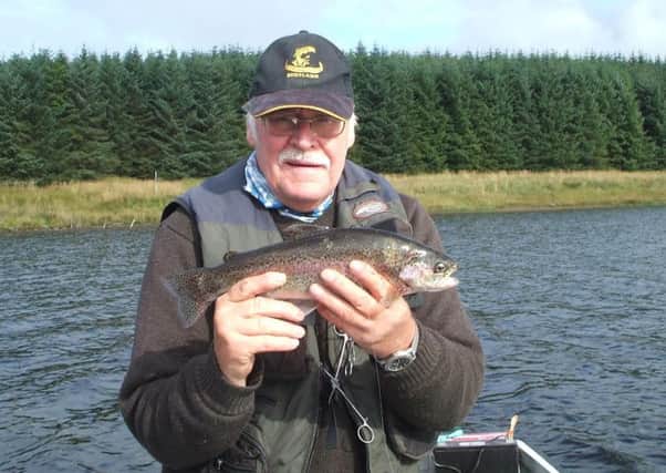 Stuart Fraser with a 3lb rainbow taken on a diawl Bach at Loch Glow