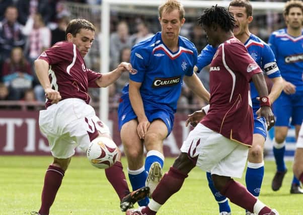 Rangers player Steven Whittaker is crowded out by Kestius Ivaskevicius and Larry Kingston