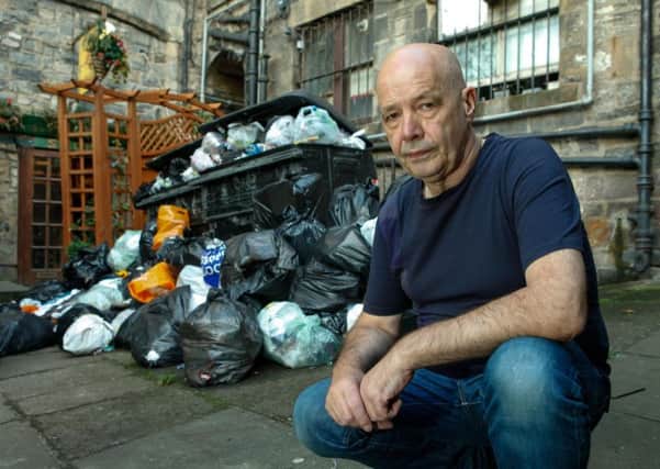 Ian McKinna from the High Street, whose bins haven't been emptied for a fortnight. Picture: Toby Williams