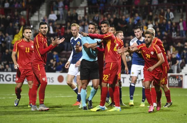 The Macedonia players alert the referee to his assistants flag amid late claims for a Scotland penalty. Picture: Craig Foy/SNS