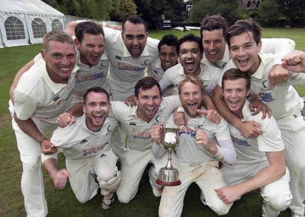 The jubilant Carlton squad celebrate their Grand Final victory with the trophy. Image courtesy of Cricket Scotland