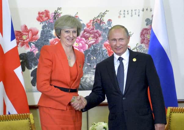 Theresa May shakes hands with Russian President Vladimir Putin during a bilateral meeting in Hangzhou, China. Picture: AP
