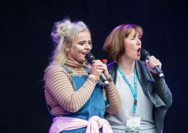 Festival opener Caitlyn Vanbeck and presenter  Arlene Stuart - who had to announce that Scouting for Girls would not be appearing