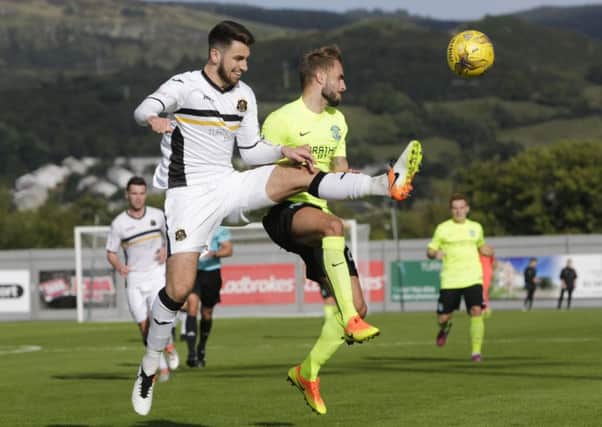 Andrew Shinnie, right, battles for possession with Gregor Buchanan of Dumbarton during Saturdays match