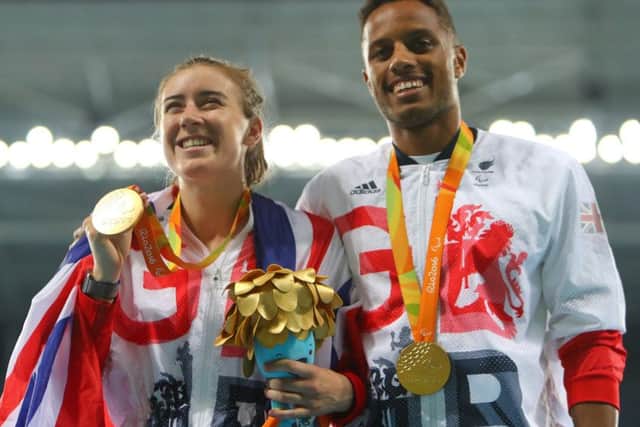 Gold medalist Libby Clegg  and her guide Chris Clarke  celebrate on the podium at the medal ceremony for the women's T11 200m. Picture:  Lucas Uebel/Getty Images