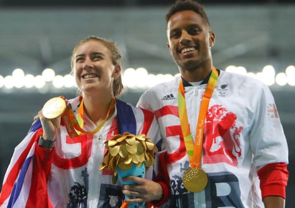 Gold medalist Libby Clegg  and her guide Chris Clarke  celebrate on the podium at the medal ceremony for the women's T11 200m. Picture:  Lucas Uebel/Getty Images