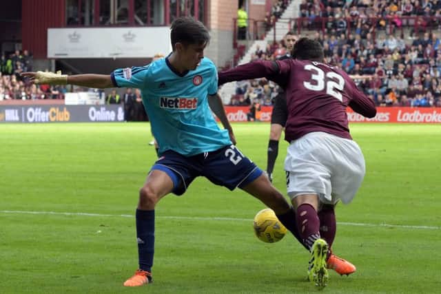 Tony Watt received a yellow card for simulation following this challenge by Hamilton's Shaun Want. Pic: Ron MacNeill Photography