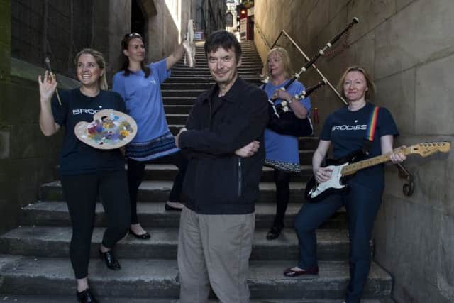 Author Ian Rankin speaks to group in Greyfriars Churchyard during a tour around Edinburgh's Old Town. Picture; TSPL