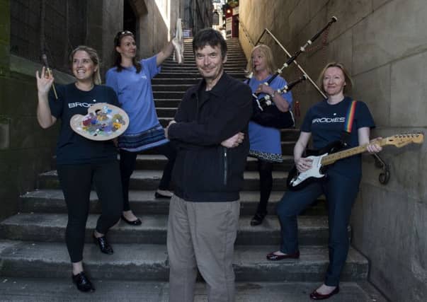 Author Ian Rankin speaks to group in Greyfriars Churchyard during a tour around Edinburgh's Old Town. Picture; TSPL