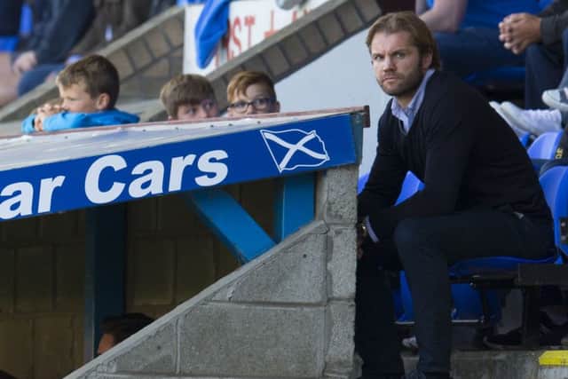 Hearts head coach Robbie Neilson watches from the stand at McDiarmid Park