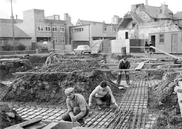 The workmen lay special foundations for the new shopping centre development at junction of South Street and St Andrews Street, Dalkeith, in the early 1960s. Photo; The Scotsman/Scran