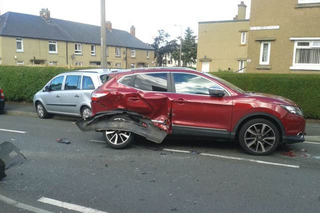 Ann Duffy from Broomhouse Grove, Edinburgh takes a look at the damage to her gate. Picture Toby Williams.