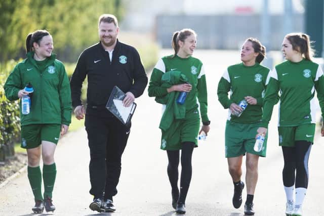 Hibs head coach Chris Roberts shares a joke with, from left, Cailin Michie, Lizzie Arnot, Lisa Robertson and Clare Williamson. Pic: SNS