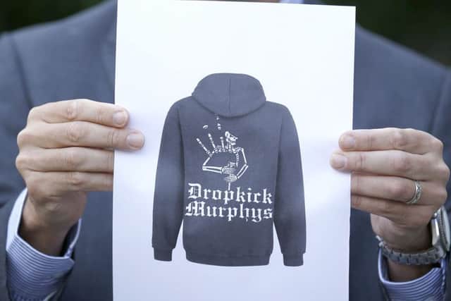 Detective Inspector Donnie MacLeod from the Public Protection Unit at Police Scotland holds a picture of a hooded top that it is believed the suspect was wearing. Picture PA