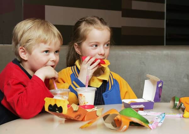 Children tuck into a Happy Meal at McDonald's. Picture: Kristian Dowling/Getty Images