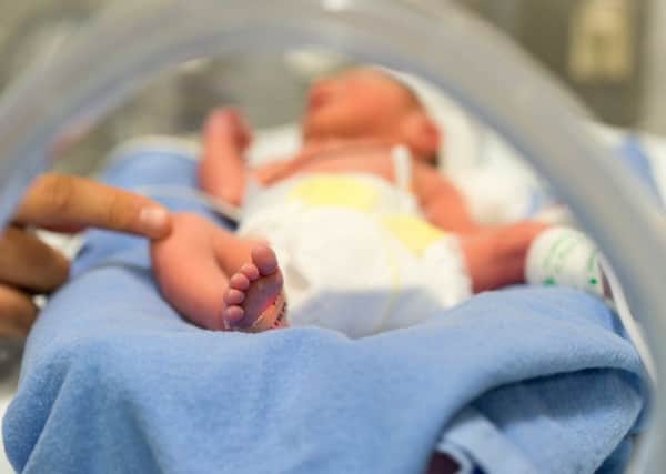 Remember grieving parents this Baby Loss Awareness Week. Picture: Getty

Photo of a premature baby in incubator. Focus is on his feet and toes. The doctor is touching him to check his reflexes. There are cables and tubes in the out-of-focus area.