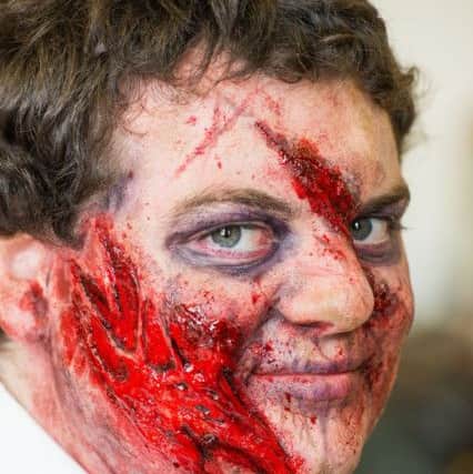 Evening News reporter James gets a zombie Make over by Special effects artist Calum MacDonald. Picture: Ian Georgeson