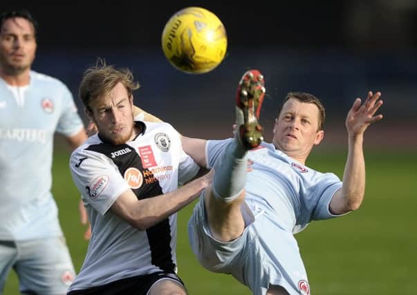 City's Mark McConnell battles with Scott McLaughlin of Clyde.   Pic: Neil Hanna