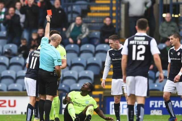 Hibs midfielder Marvin Bartley looks bemused as referee Stephen Finnie flashes the red card at him following a clash with Raith Rovers' Bobby Barr