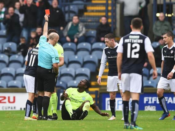 Hibs midfielder Marvin Bartley looks bemused as referee Stephen Finnie flashes the red card at him following a clash with Raith Rovers' Bobby Barr