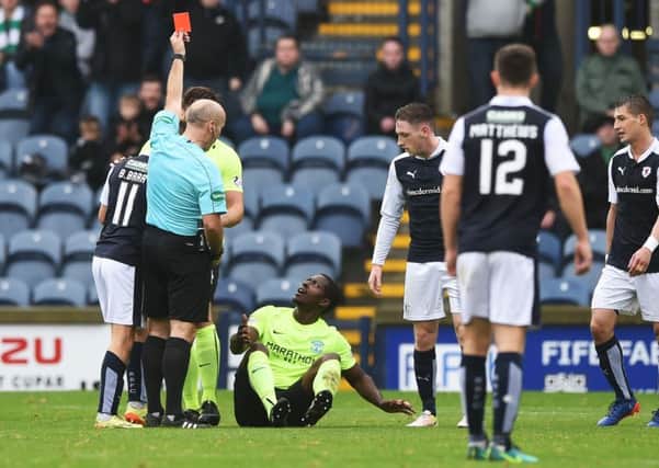 Referee Stephen Finnie shows Marvin Bartley a hotly-contested red card. Pic: SNS