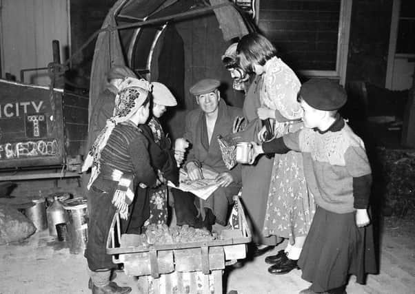 Hallowe'en guisers visit a night watchman in the Grassmarket in 1957