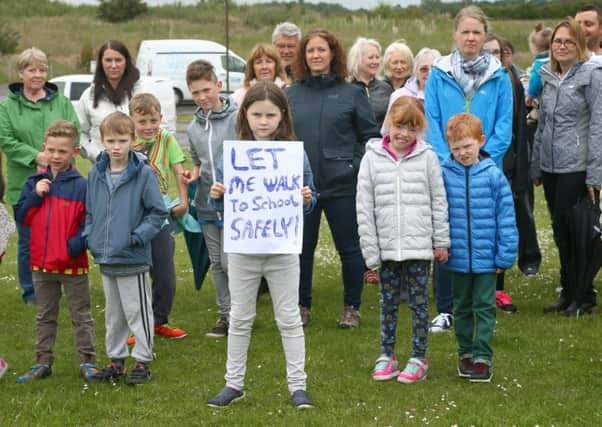 Protesters, pictured in July, opposed plans to direct site traffic through the existing estate.