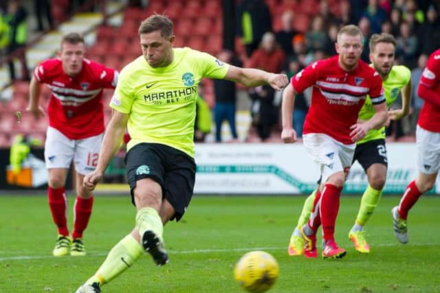 Hibs striker Grant Holt fires his side ahead from the penalty spot to set up their first win in six games