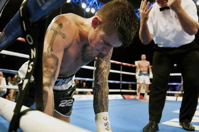 A primed Josh Taylor waits in the background as Dave Ryan tries to recover from a bodyshot. Pic: Ian Rutherford