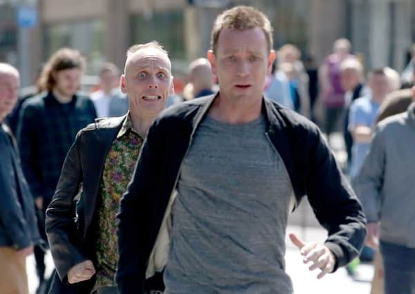 Actors Ewan McGregor  and Ewan Bremner running through the streets of Edinburgh filming scenes for the new Trainspotting.  Picture; Jane Barlow