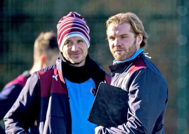 Robbie Neilson, right, ponders team matters during training alongside his assistant Stevie Crawford