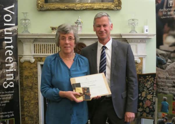Garden volunteer Lesley Cumming receives an award from National Trust for Scotland Chief Executive Simon Skinner.