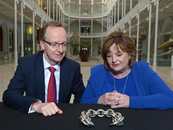 National Museums Scotland director Dr Gordon Rintoul and Scottish culture secretary Fiona Hyslop examine an early medieval silver chain from Torvean, near Inverness.