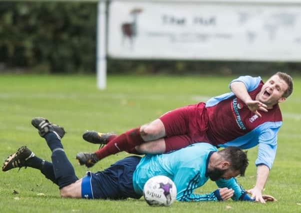 Chris Cairney, in maroon, saw red for Haddington but the home side still claimed a huge win. Pic: Ian Georgeson