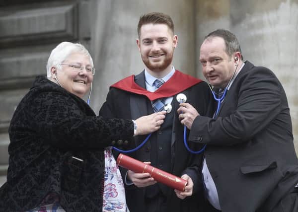 Newly graduated nurse Fraser Chalmers is pictured with his father Ross, who is in his 3rd year on the same course, and his mother Sarah who already works as a district nurse. Picture: Greg Macvean
