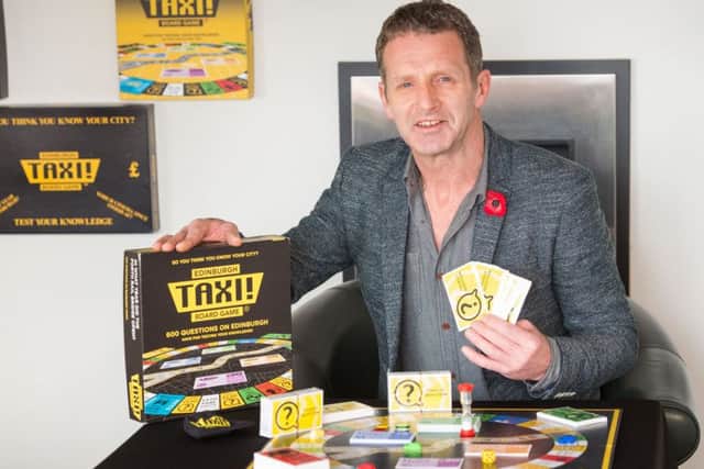 Derek Carroll with his Taxi board game. Picture: Ian Georgeson