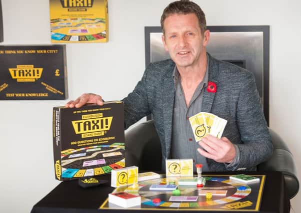 Derek Carroll with his Taxi board game. Picture: Ian Georgeson