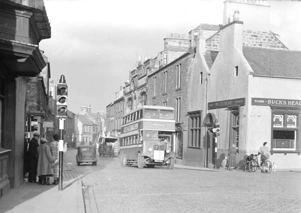 A bus stops at traffic lights at the High Street, Dalkeith, Midlothian. It was announced in 1953 that a one-way system was to be introduced to ease the bottleneck in the High Street.