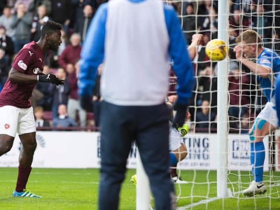 Prince Buaben heads the opening goal at Tynecastle as St Johnstone's Brian Easton desperately tries to clear.