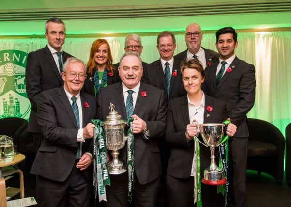 Hibs chairman Rod Petrie, centre, holds the Scottish Cup and chief executive Leeann Dempster, right, holds the Ladies Scottish Cup with fellow directors before the clubs AGM last night. Picture: Ian Georgeson
