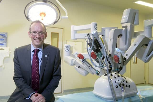 Professor Alan McNeill, Consultant Urological Surgeon, at the Western General Hospital with the robotic machine. Picture: Sandy Young