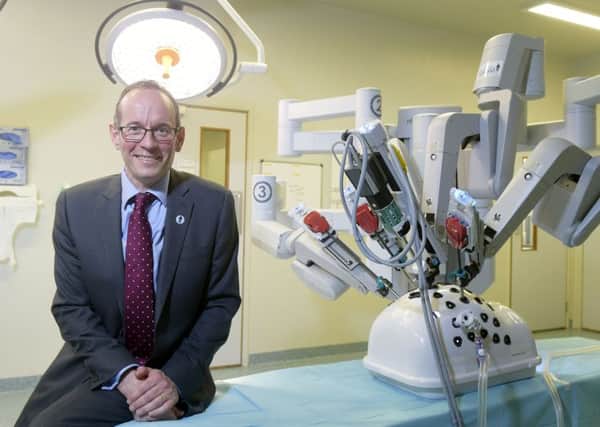 Professor Alan McNeill, Consultant Urological Surgeon, at the Western General Hospital with the robotic machine. Picture: Sandy Young