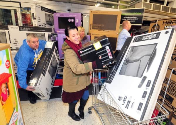 Shoppers grab bargain Christmas presents at Asda on a previous Black Friday. Picture by Tony Johnson