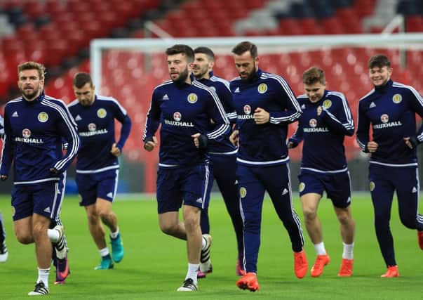 The Scotland squad, including Hearts defender Callum Paterson, fourth right, train at Wembley ahead of tonight's World Cup clash with Eng;and