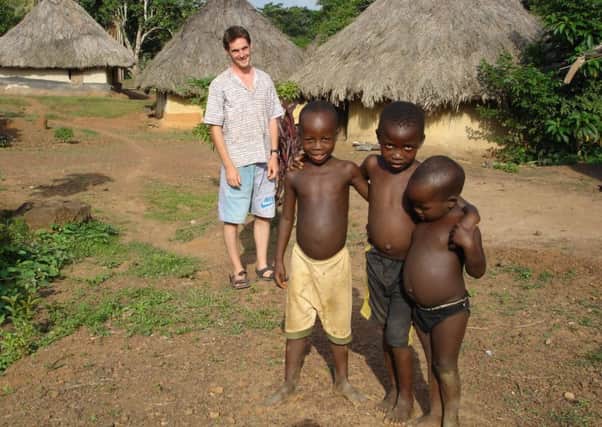 Alex Keay with children he helped in Liberia. Picture: contributed